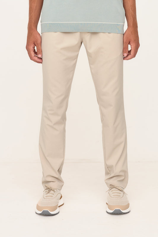 Person wearing beige pants and a light blue shirt on a white background